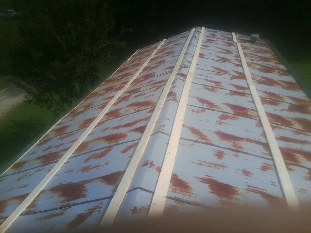 Rusted metal roof panels with new wood purlins before replacement — Storm Damage Roof Repair in Morgan Hill by Roofing Brothers