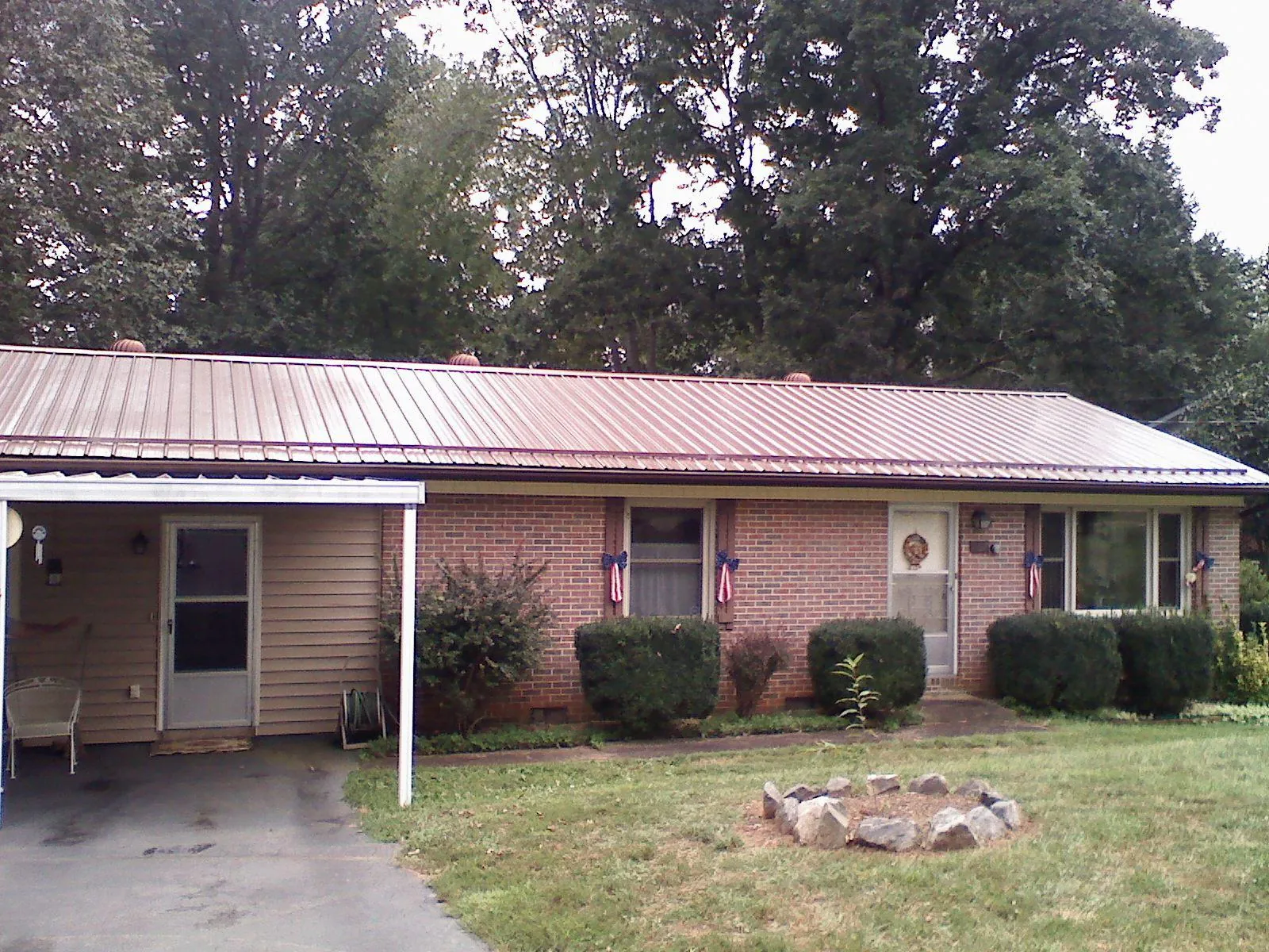 Bronze metal roof and carport on a brick ranch home — Roof Repair work by our crew in Morgan Hill