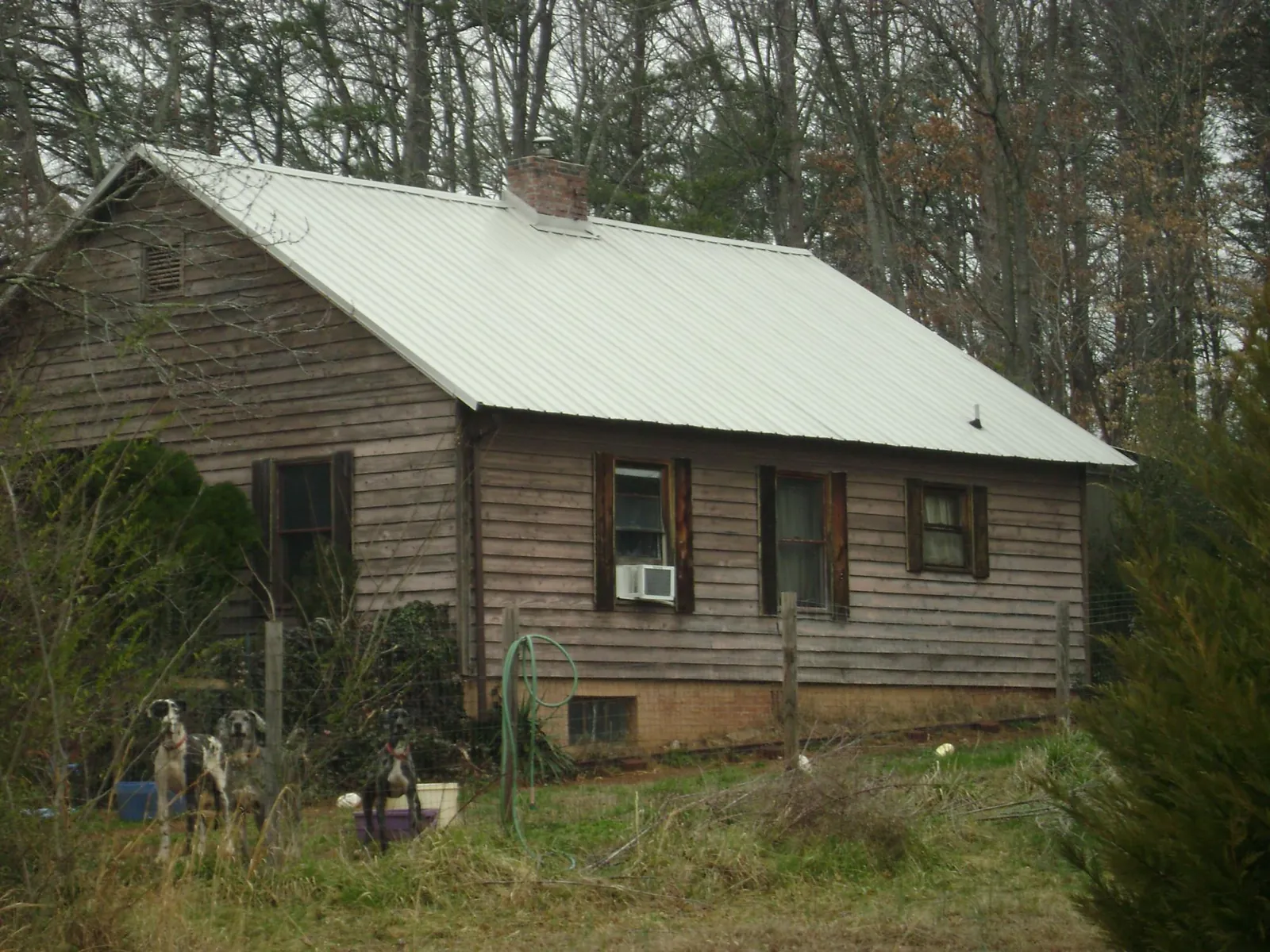 White metal roof on an old wood sided farmhouse, from a Metal Roof Installation job in Morgan Hill